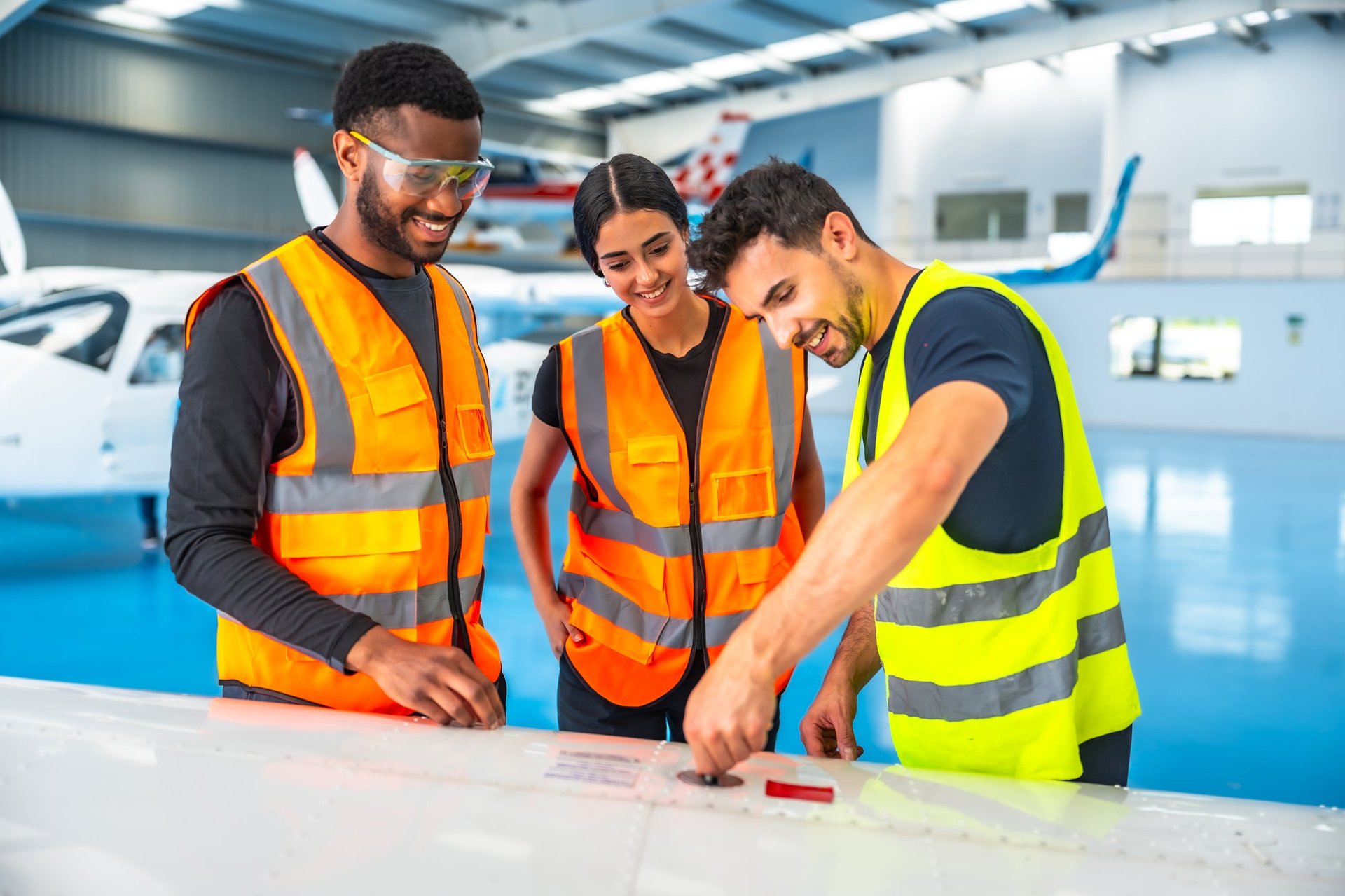 Three Ghanaian aircraft maintenance technicians working together