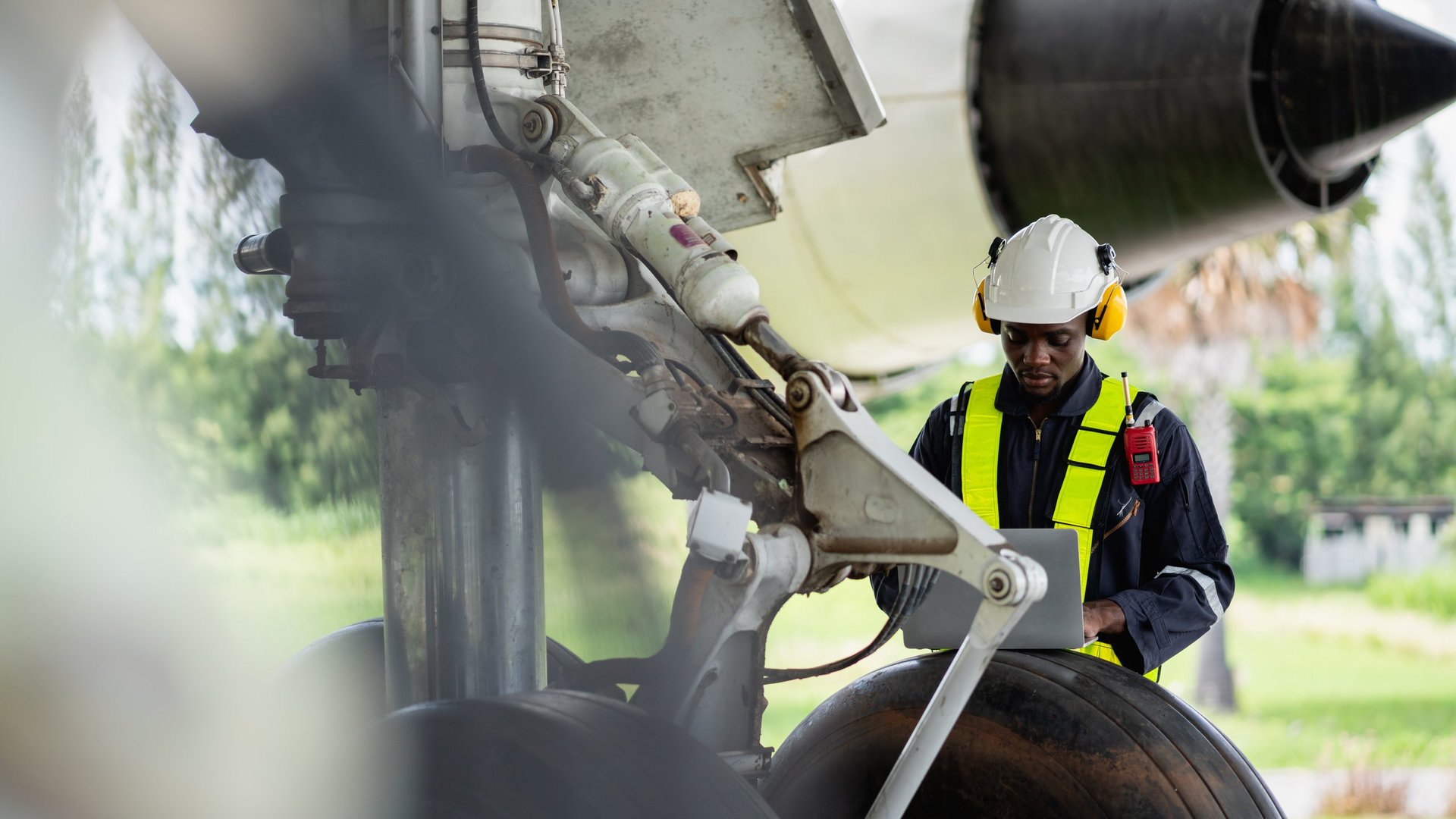 Aircraft maintenance engineer inspecting engine with tools