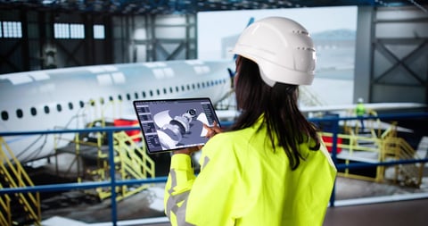 Female aerospace engineer conducting detailed aircraft engine inspection
