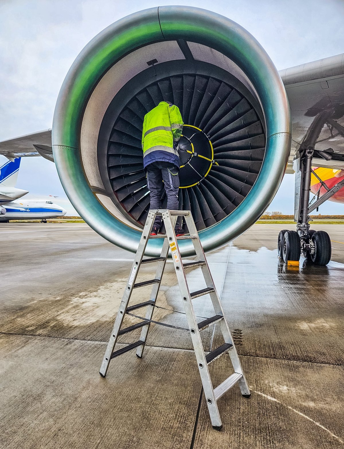 Aircraft technician performing detailed engine inspection