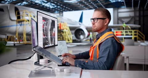 Ghanaian aircraft maintenance engineer inspecting aircraft components in high-visibility vest