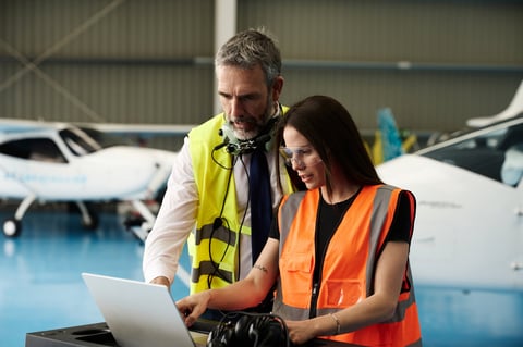 Three Ghanaian aircraft maintenance technicians working together in hangar